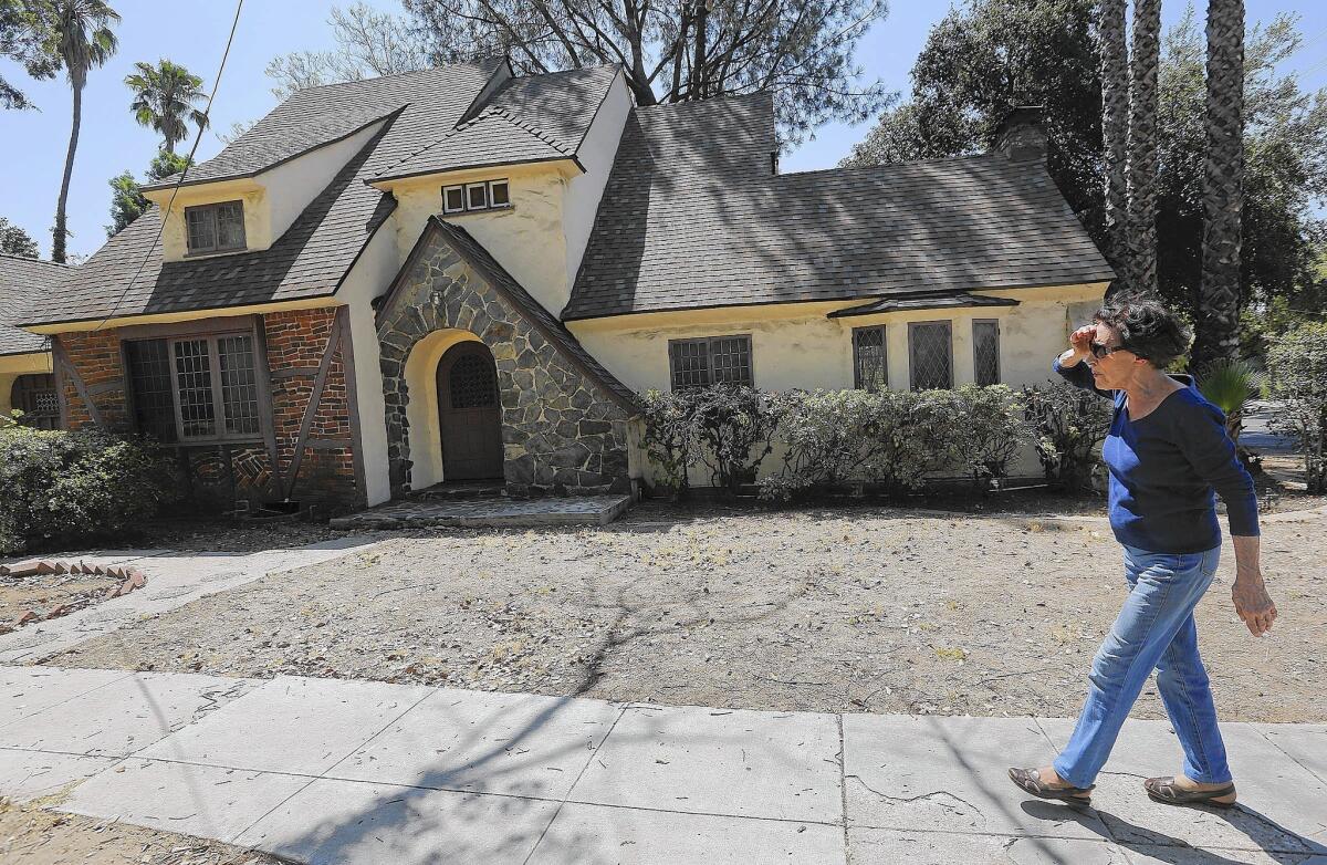 Yolande Treuscorff, 88, of Pasadena has watched the Caltrans-owned house next door deteriorate in the 12 years it’s been unoccupied. She worries that it will be difficult to sell because it needs so much work.