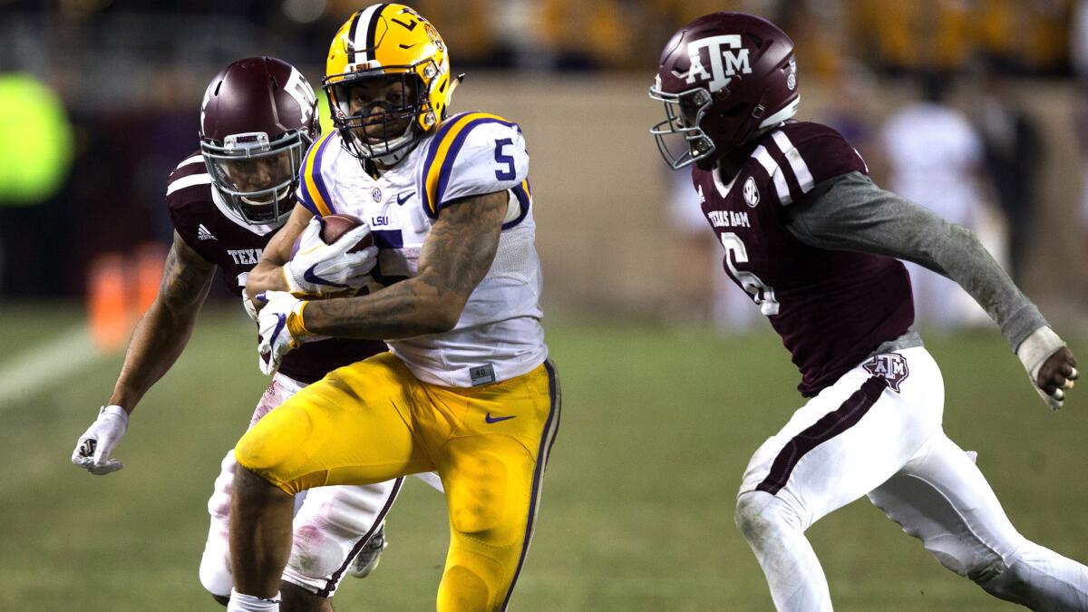 LSU running back Derrius Guice tries to get past a pair of Texas A&M defenders on a run in the second half Thursday.