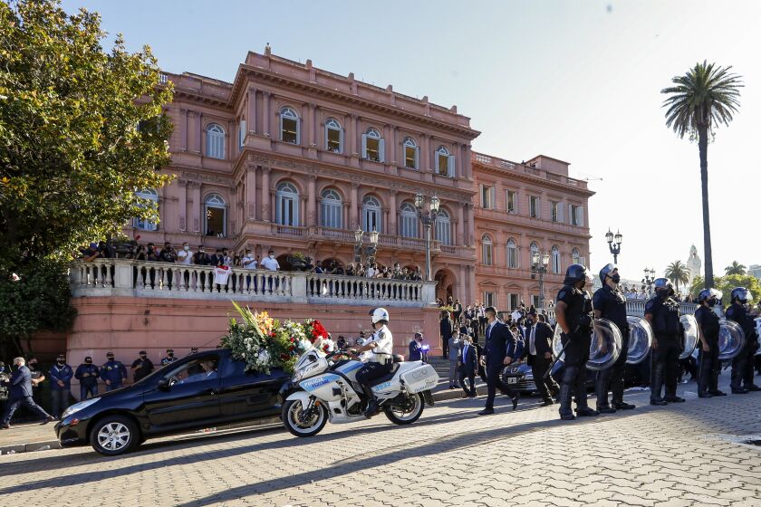 A caravan carrying the casket of Diego Maradona to his final resting place departed the Casa Rosada presidential palace in Buenos Aires, Argentina, Thursday, Nov. 26, 2020. The Argentine soccer great who was among the best players ever and who led his country to the 1986 World Cup title died from a heart attack at his home Wednesday at the age of 60. (AP Photo/Natacha Pisarenko)