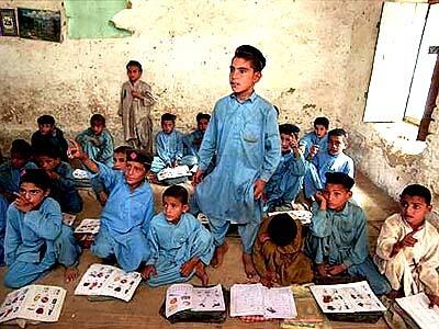 Afghan children attend a class at a Jalozai refugee camp.
