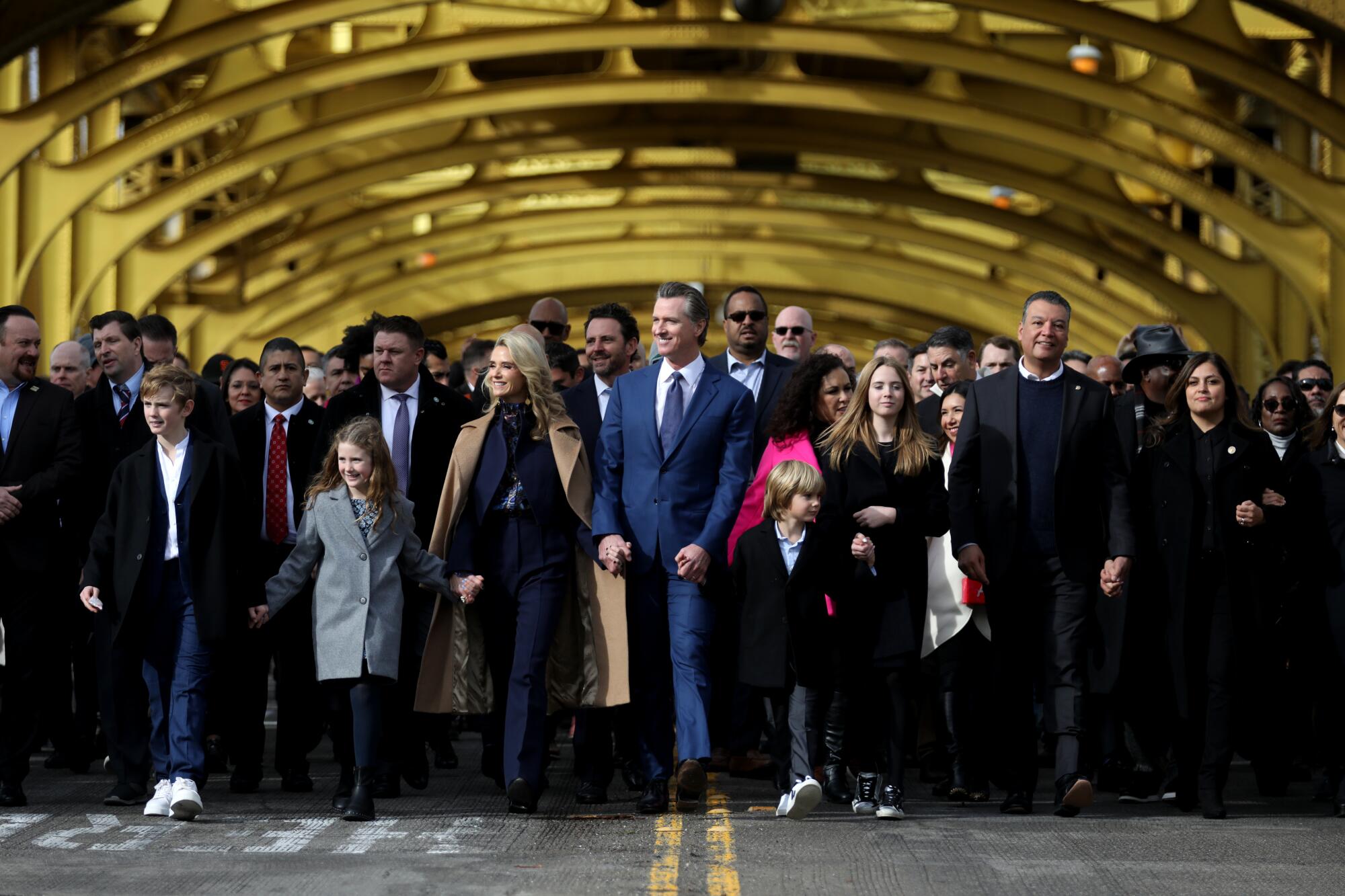 Gov. Gavin Newsom marches with others down a street