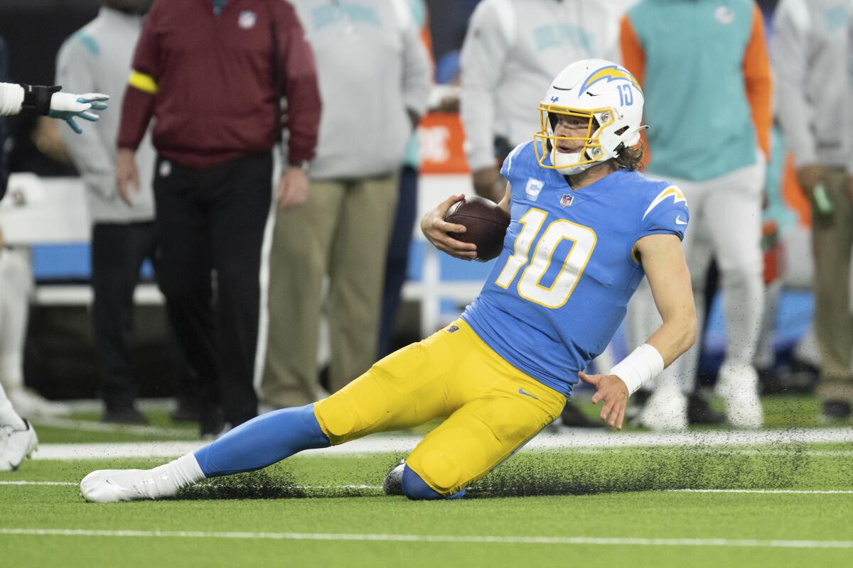 Chargers quarterback Justin Herbert slides during a win over the Miami Dolphins on Dec. 11.