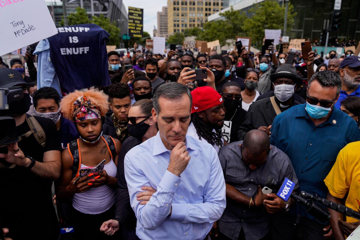 L.A. Mayor Eric Garcetti in the middle of a crowd of protesters