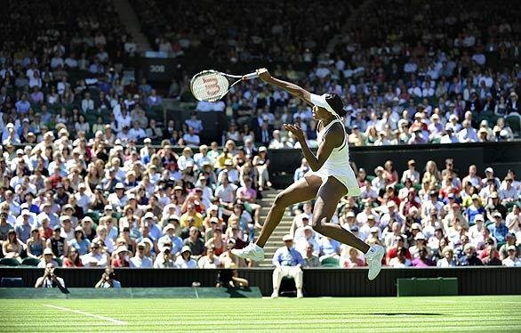 Venus Williams returns a ball to Switzerland's Stefanie Voegele during their first-round match at Wimbledon. The event, the third Grand Slam tournament of 2009, runs from June 22 to July 5.