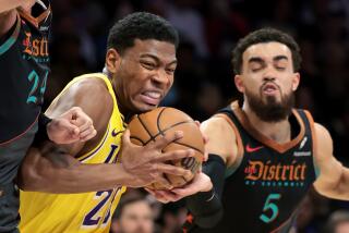 Los Angeles, California February 29, 2024-Lakers Rui Hachimura drives to the basket against Wizards Tyus Jones in second quarter at Crypto.com Arena Thursday. (Wally Skalij/Los Angeles Times)