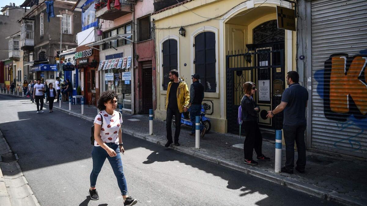 People walk Sunday in front of Dirilis (Resurrection) Church, where Andrew Brunson had his congregation, in Izmir, Turkey.