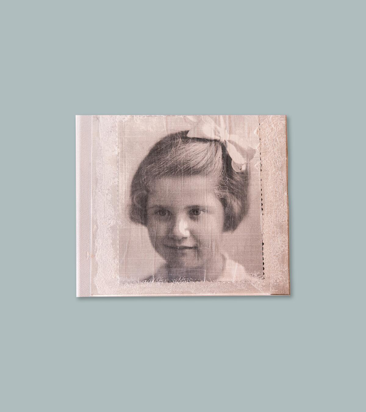 A scan of a photograph of a young Josie Levy Martin, who is wearing a bow in her hair.