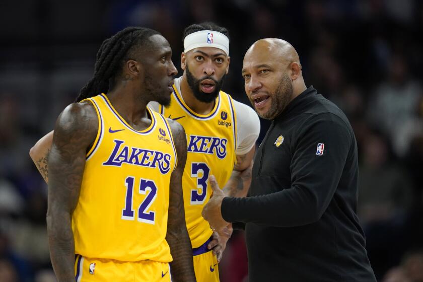 Los Angeles Lakers head coach Darvin Ham talks with forwards Taurean Prince (12) and Anthony Davis.