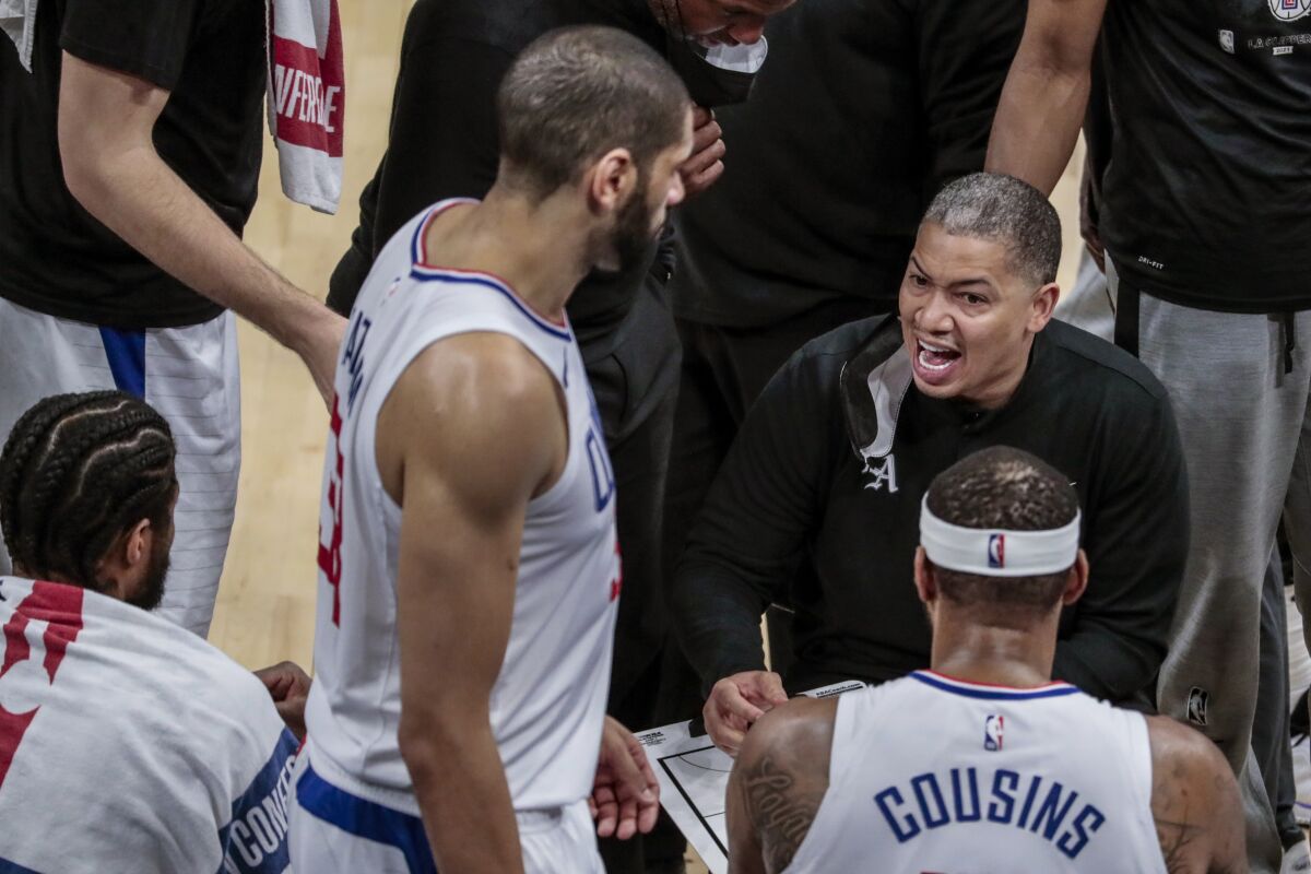 Clippers coach Tyronn Lue talks strategy with the team during a break in Game 1.