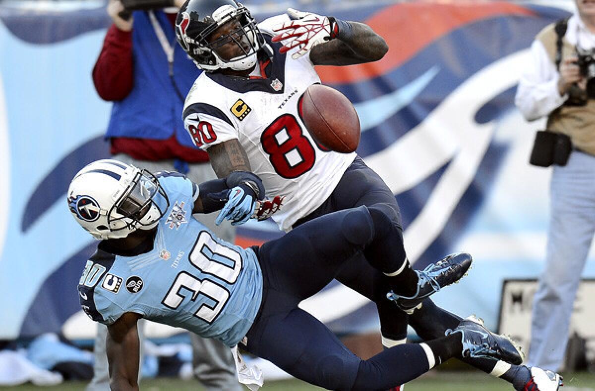 The Texans should be getting some quality help with the No. 1 selection in next spring's NFL draft. Above, a pass Sunday to Texans receiver Andre Johnson, shown at top, is broken up by Titans cornerback Jason McCourty.