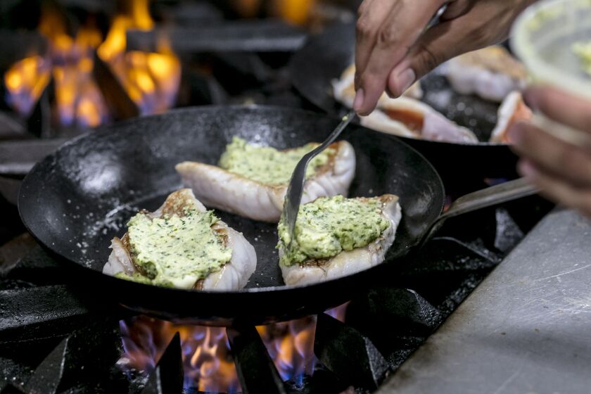 LOS ANGELES, CALIFORNIA - July 19, 2019: A cook prepares market fish with herb-crust butter at Pikoh on Friday, July 19, 2019, at the Ricardo Zarate's new Peruvian-influenced bistro on Pico Blvd. (Silvia Razgova / For The Times) Assignment ID: 459345