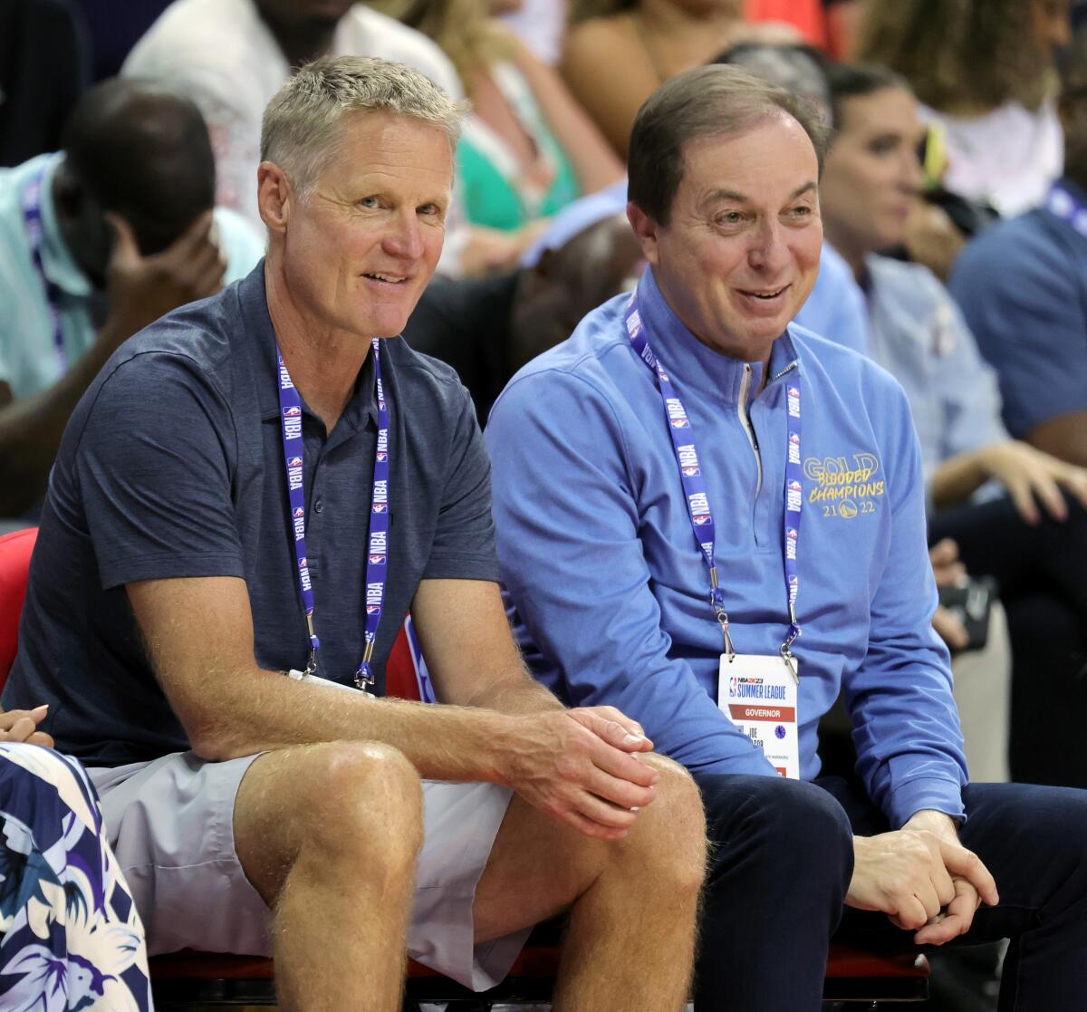 Warriors coach Steve Kerr, left, and owner Joe Lacob watch a summer league game on July 10, 2022, in Las Vegas.