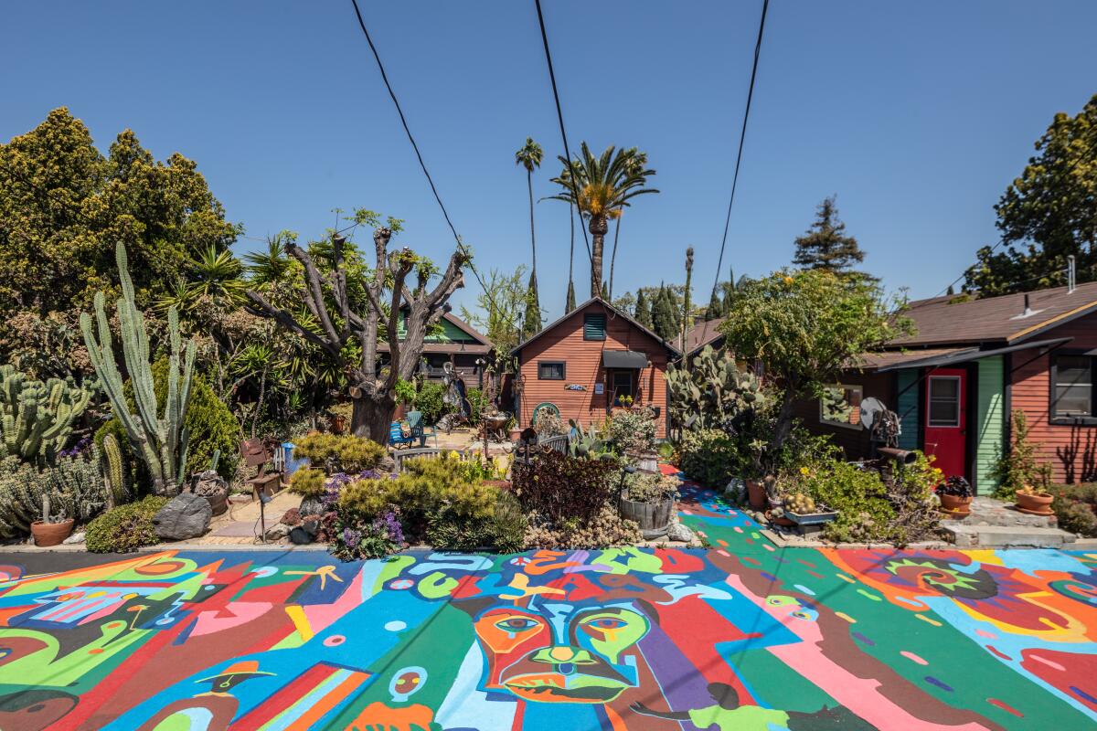 Craftsman bungalows are surrounded by desert gardens and colorful floor murals