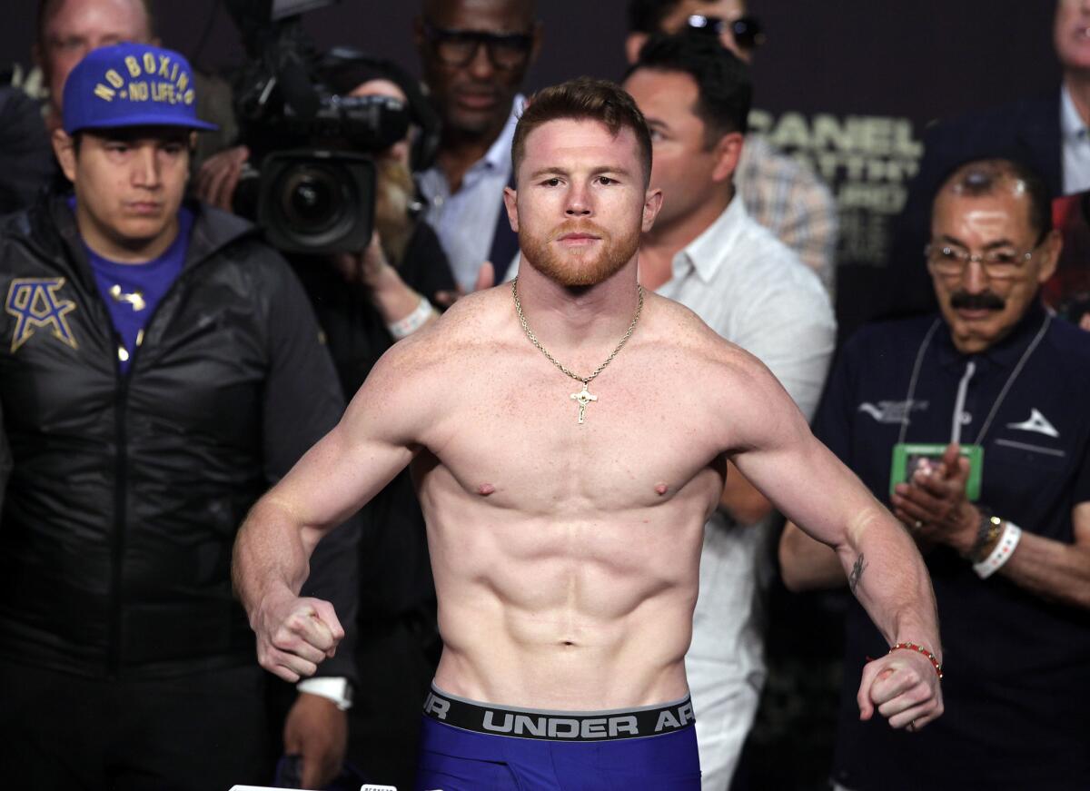 (FILES) In this file photo taken on May 05, 2017 Boxer Saul "Canelo" Alvarez poses on the scales during his weigh-in with Julio Cesar Chavez, Jr. at the MGM Grand Arena in Las Vegas, Nevada. - Saul "Canelo" Alvarez bids to extend his dominance of the middleweight division here May 4, 2019, when he takes on Daniel Jacobs in an eagerly anticipated unification bout. Mexican icon Alvarez is putting his World Boxing Association and World Boxing Council titles on the line when he faces Jacobs at the T-Mobile Arena aiming to claim the American's International Boxing Federation belt.