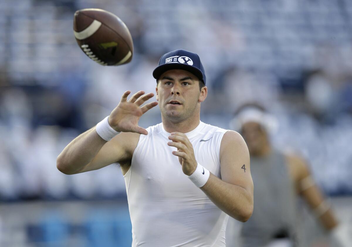 BYU quarterback Tanner Mangum catches a pass during practice before a game against Boise State on Sept. 12.