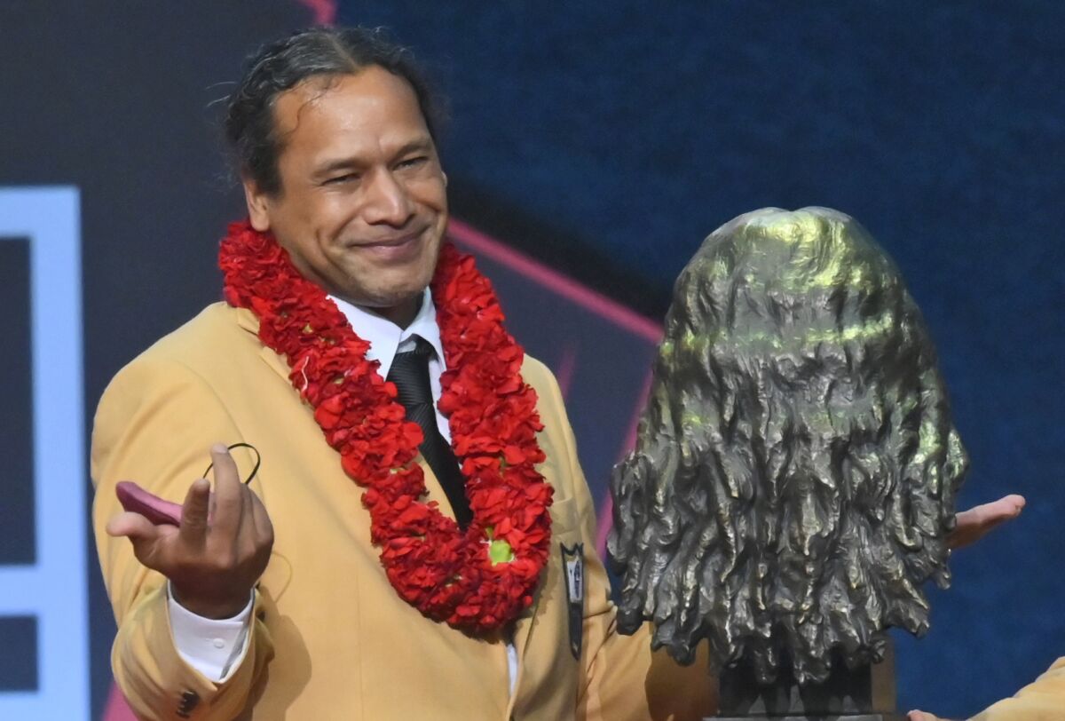 Troy Polamalu, a member of the Pro Football Hall of Fame Centennial Class, smiles after his bust was unveiled during the induction ceremony at the Pro Football Hall of Fame, Saturday, Aug. 7, 2021, in Canton, Ohio. (AP Photo/David Richard)