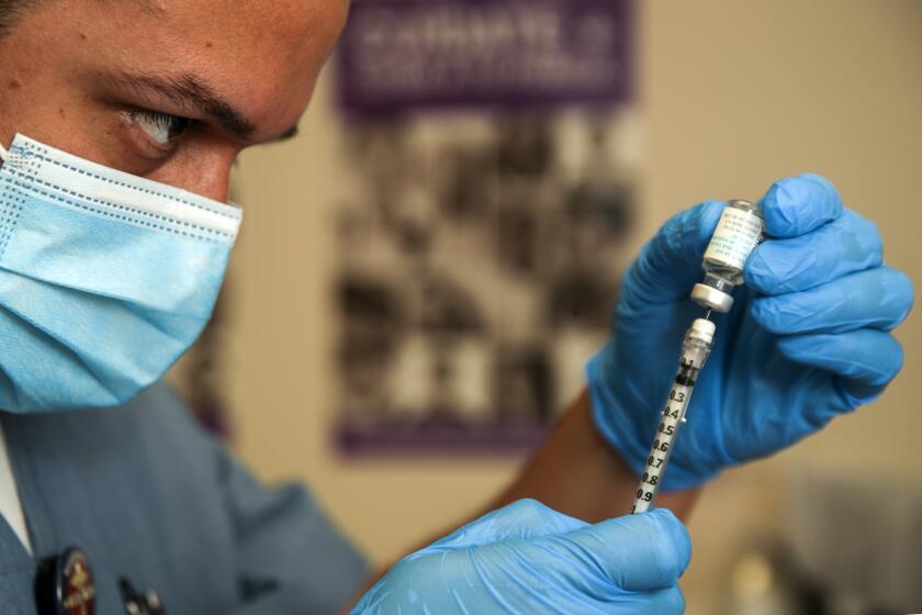 Los Angeles, CA - August 10: Luis Garcia, a registered nurse, prepares Monkeypox virus vaccine at St.John's Well Child & Family Center on Wednesday, Aug. 10, 2022 in Los Angeles, CA. (Irfan Khan / Los Angeles Times)