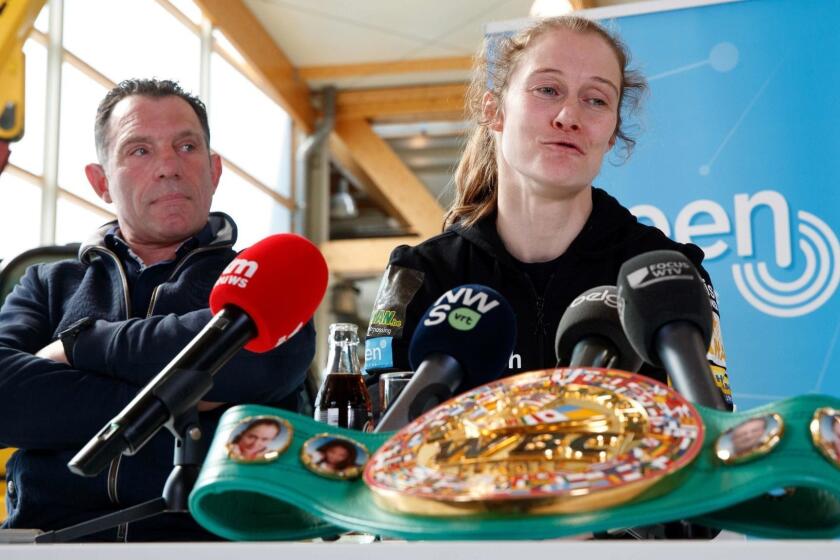 Coach Filiep Tampere and Delfine Persoon,10-time WBC World Champion, sit together during a press conference prior to her upcoming fight in the US against Ireland's Katie Taylor on April 15, 2019, in Zedelgem. - Persoon, 34, will fight Irish Taylor, 32, in Madison Garden, New York, on June 1, 2019, to unify the WBC, WBO, WBA, IBF female lightweight titles. (Photo by KURT DESPLENTER / various sources / AFP) / Belgium OUTKURT DESPLENTER/AFP/Getty Images ** OUTS - ELSENT, FPG, CM - OUTS * NM, PH, VA if sourced by CT, LA or MoD **