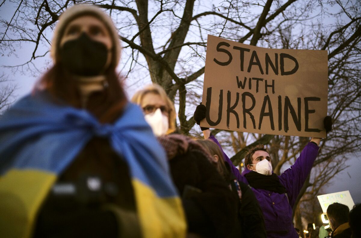 A man holds a poster in support of Ukraine