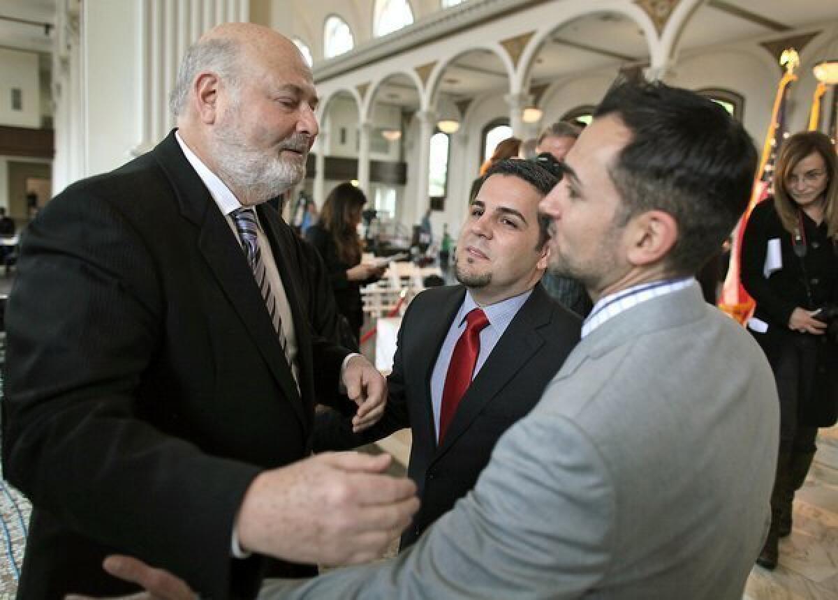 Rob Reiner, left, chats with plaintiffs Paul Katami, right, and Jeff Zarillo at a news conference last year in Los Angeles.