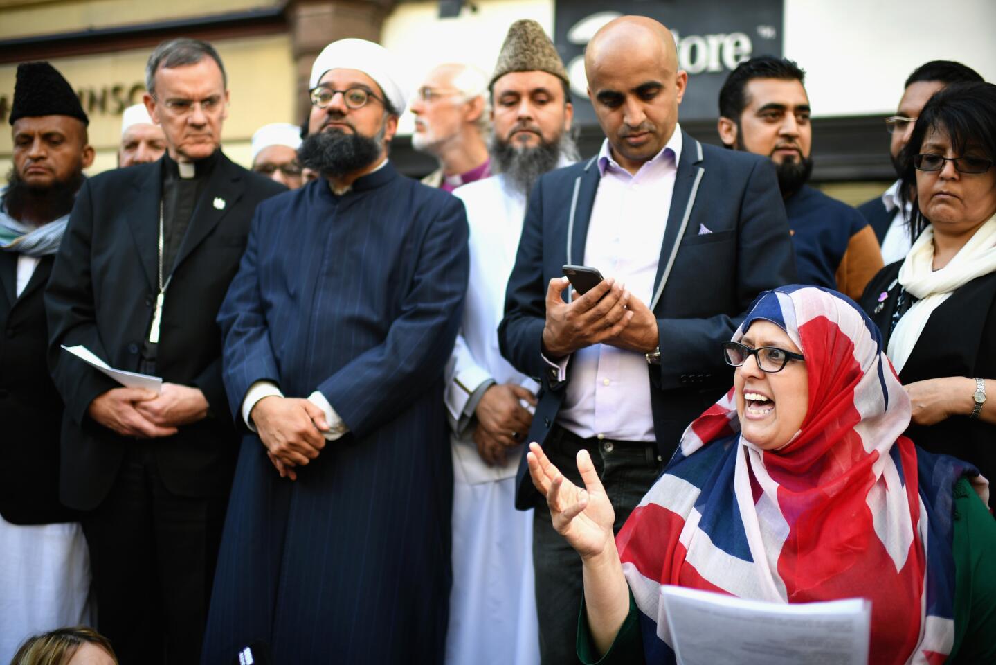 Manchester resident Gulnar Bano Kham Ghadri wears a British flag headscarf during a vigil by multicultural religious leaders in St. Ann's Square on May 24, 2017.