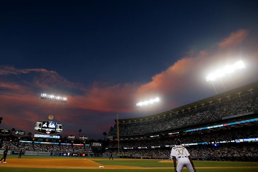 LOS ANGELES, CALIF. - JULY 19, 2022. The setting sun casts a rosy glow over Dodger Stadium.