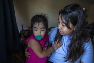 East Los Angeles, CA - August 10: Portrait of Ruby Marquez, age 2, left, with her sister Esmeralda Marquez, 11, at their home on Wednesday, Aug. 10, 2022, in East Los Angeles, CA. Esmeralda will be attending sixth grade this year. Esmeralda says she deals with anxiety when she is around others not wearing masks in public during the pandemic. Ruby, her younger sister was born prematurely and spent months in the hospital. Esmeralda explains she needs to be cautious to protect her sister who still deals with health issues. (Francine Orr / Los Angeles Times)