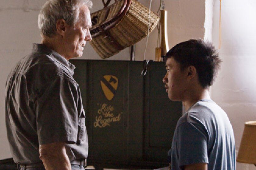 SOFTENING: Walt Kowalski (Clint Eastwood), left, is drawn into the plight of the fatherless Thao (Bee Vang).