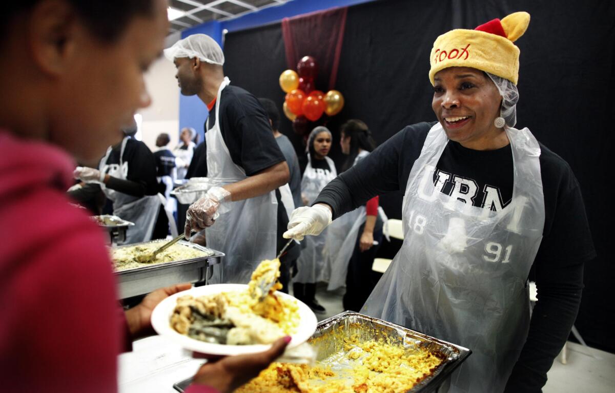 Volunteer Monica Smith serves up a Thanksgiving meal at the Union Rescue Mission in Los Angeles last year.