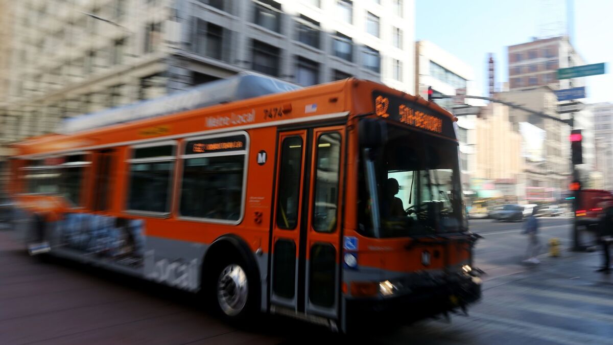 A Metro bus motors down Third Street in downtown Los Angeles.