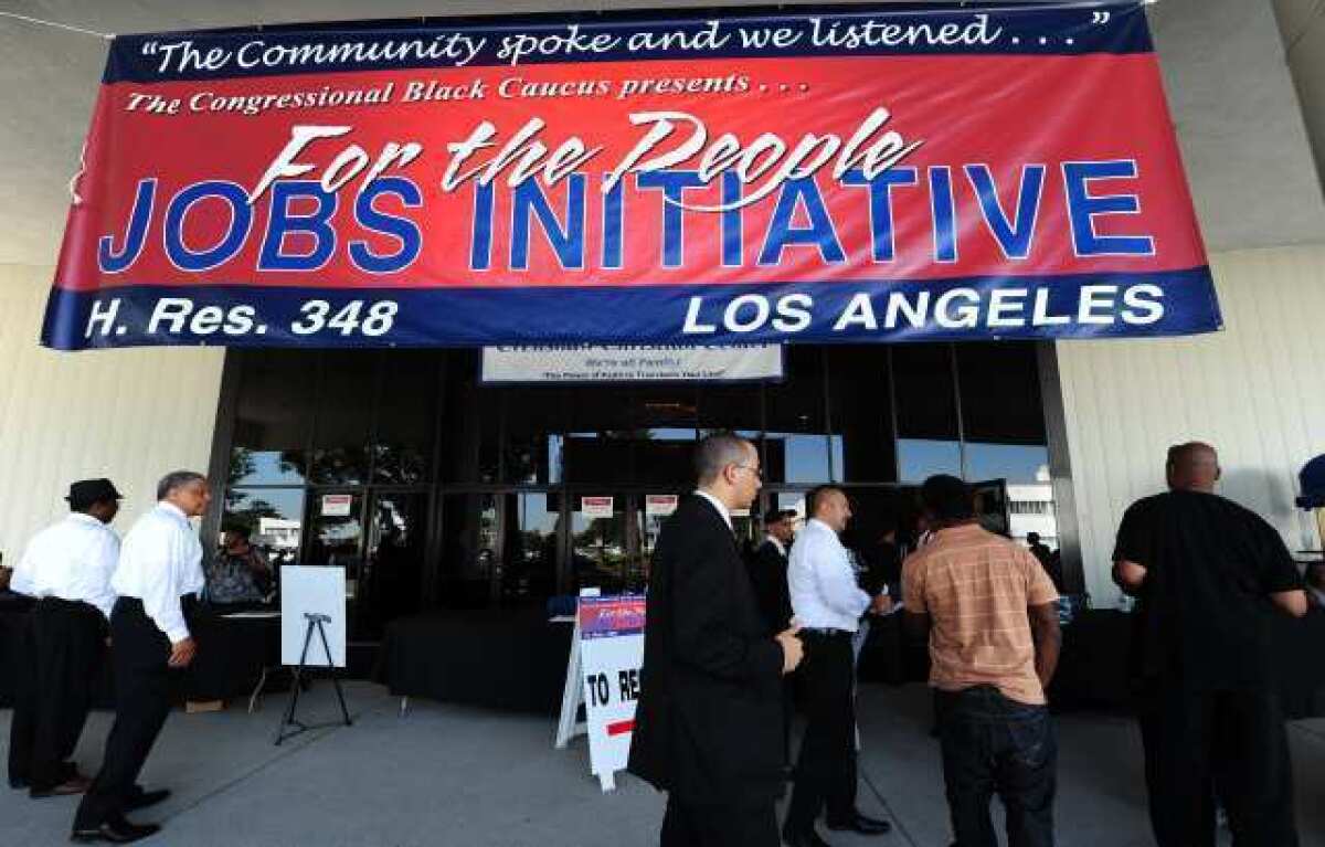 Job seekers arrive at an outdoor job fair at the Crenshaw Christian Center in South Los Angeles. A new ADP report shows private employers upping their job counts in March.