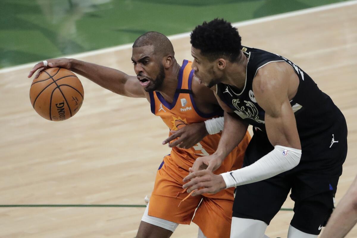 Phoenix Suns guard Chris Paul drives to the basket against Milwaukee Bucks forward Giannis Antetokounmpo.