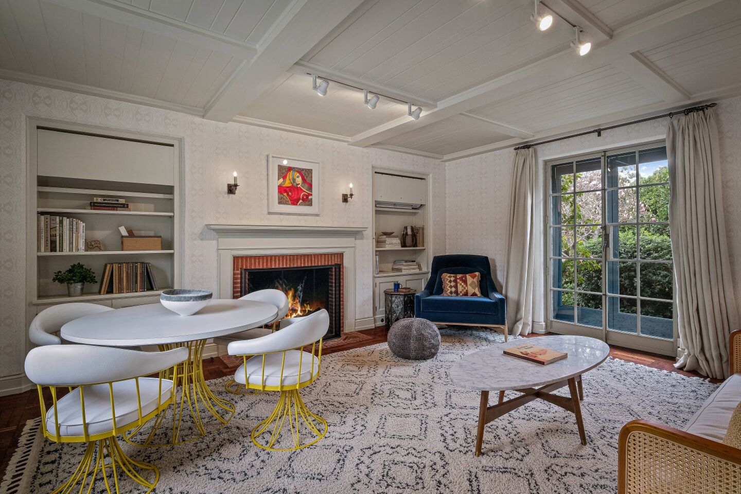 Guesthouse living area with a fireplace and window