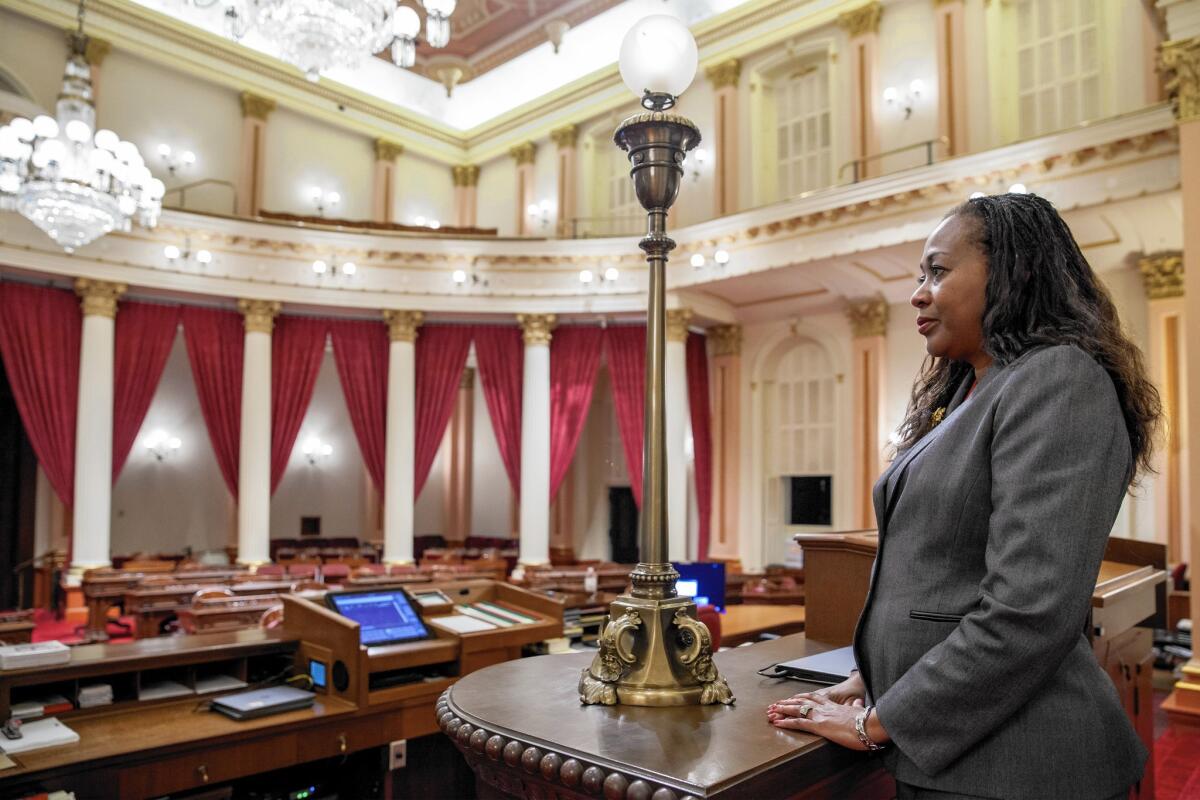 Debbie Manning, new chief of the California Senate sergeants-at-arms, stands at her post, overlooking the Senate floor.