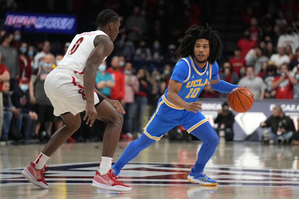UCLA guard Tyger Campbell dribbles.