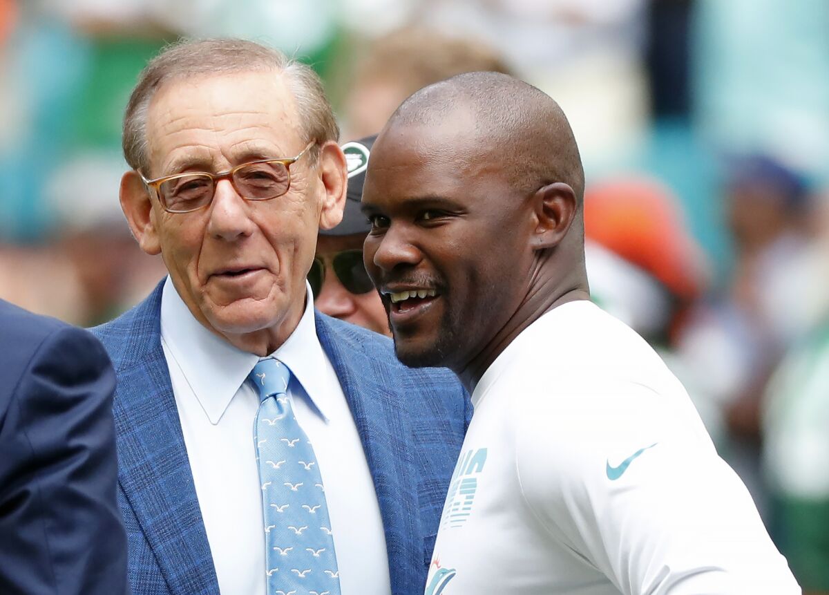 Brian Flores, right, talks to Dolphins owner Stephen M. Ross during a practice in 2019.