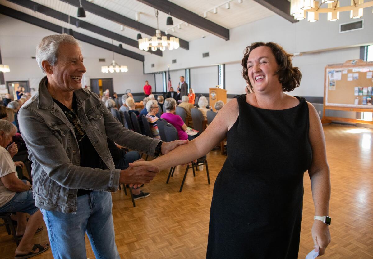 Rep. Katie Porter shakes hand with a voter in Huntington Beach