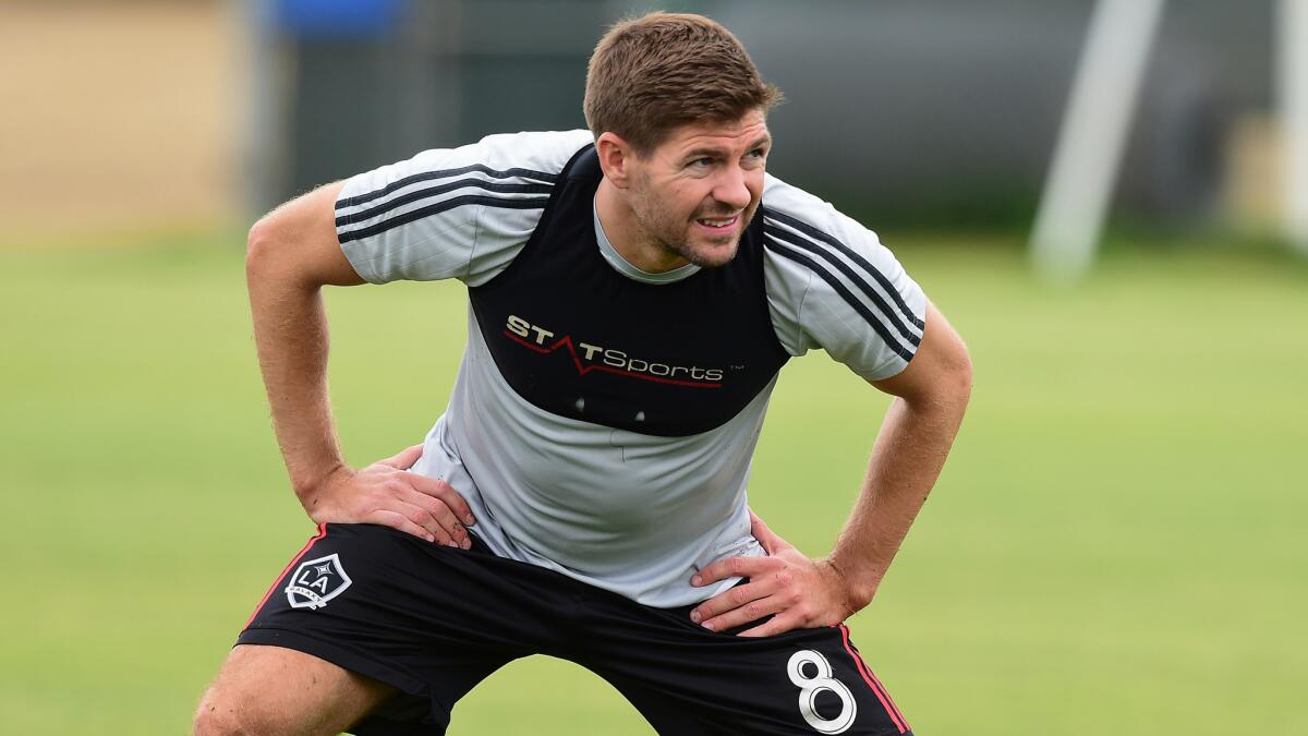 Former Liverpool star Steven Gerrard stretches while training with his new Galaxy teammates in Carson on July 7.
