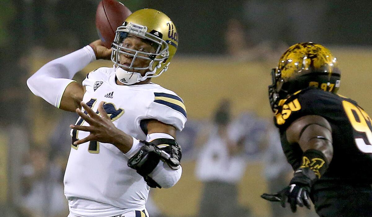UCLA quarterback Brett Hundley makes a pass under pressure from Arizona State in the first quarter.