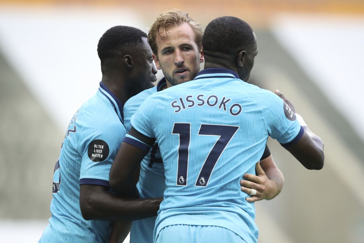 Tottenham's Harry Kane, center, celebrates after scoring his side's third goal during the English Premier League soccer match between Newcastle United and Tottenham Hotspur at St. James' Park in Newcastle, England, Wednesday, July 15, 2020. (Owen Humphreys/Pool via AP)