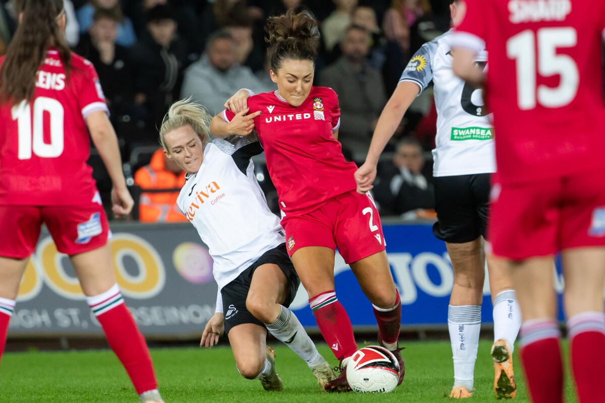 Robyn Pinder of Swansea City tackles Phoebe Davies of Wrexham