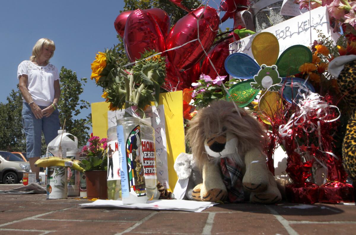 Pictured in 2011, Cathy Thomas stands at a memorial near the spot where her son Kelly was beaten to death by Fullerton police officers in 2008.