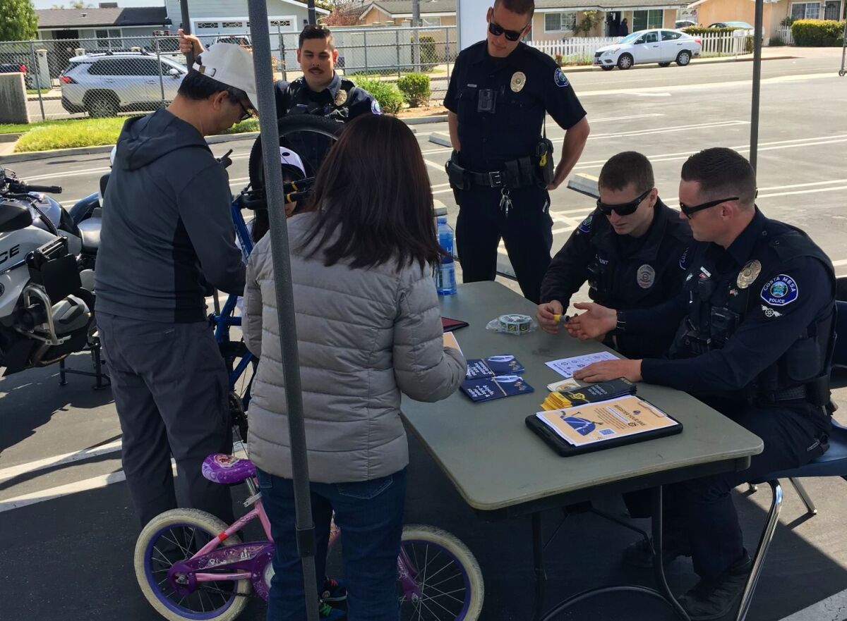 Costa Mesa police officers at a bicycle safety event Saturday encourage locals to register their bikes through Project 529.