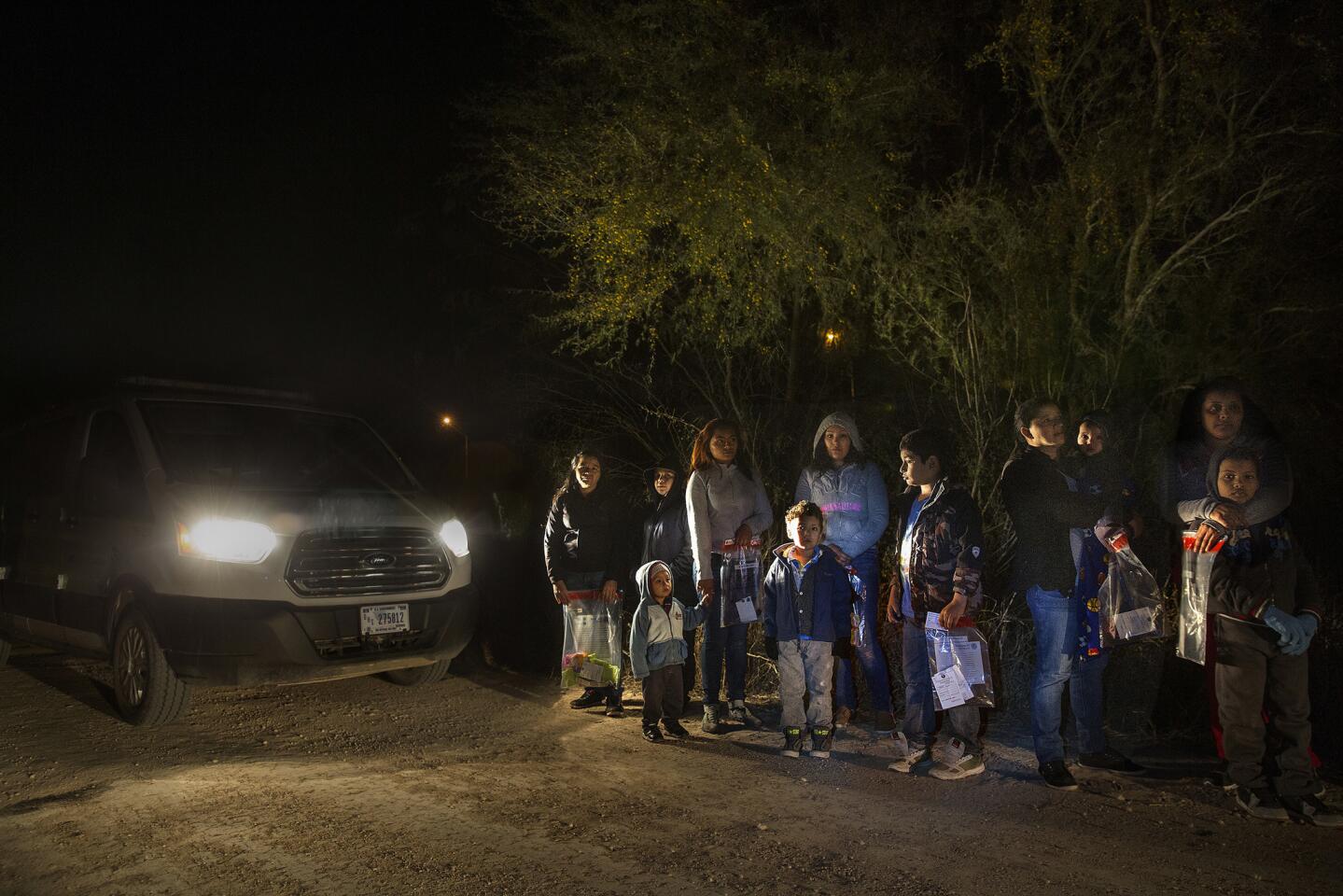 After crossing the Rio Grande River at night with the help of smugglers, group of mainly women and children from Central America are detained by U.S. Border Patrol agents before being taken into detention.
