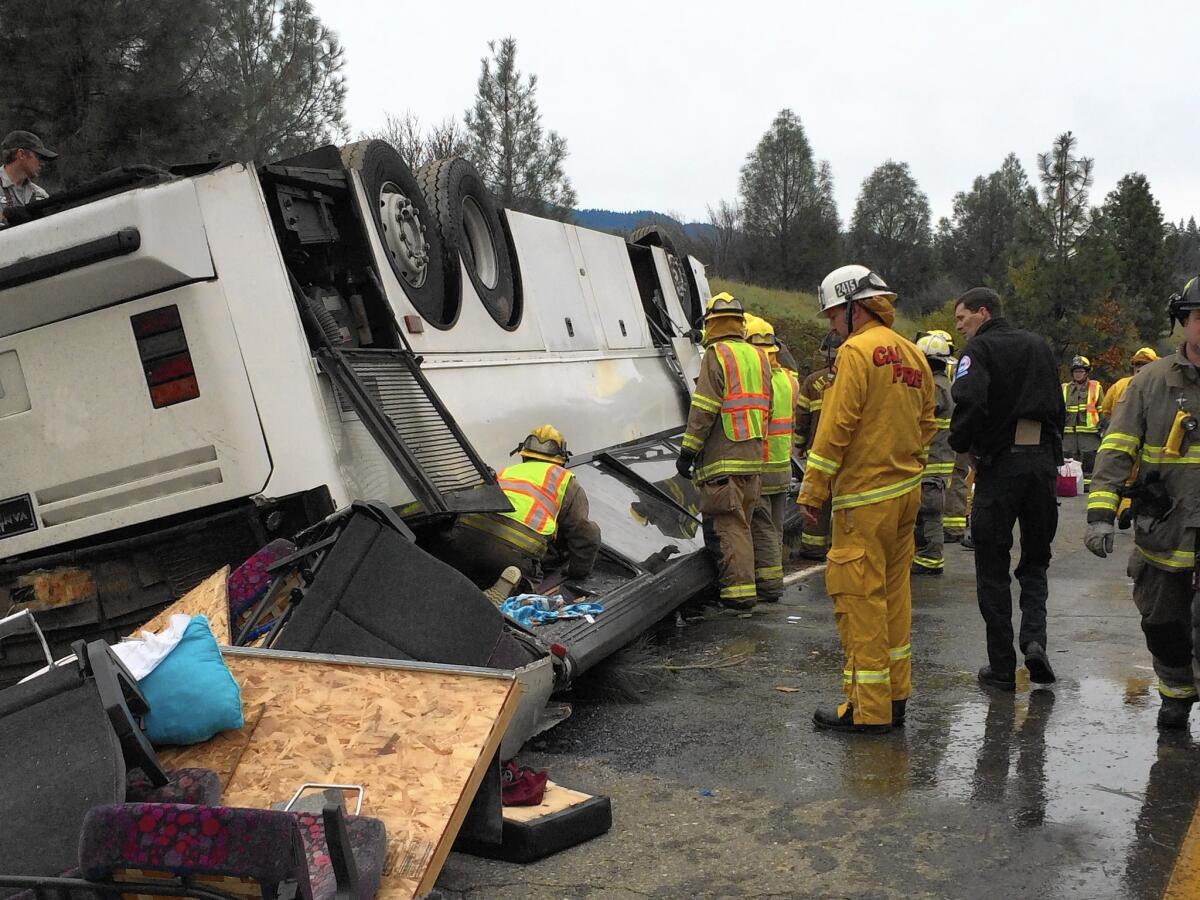 Emergency crew checks a tour bus that had already crashed earlier in the day overturned just off Interstate 5 in Northern California, killing one person and sending dozens to hospitals near the Pollard Flat area in Redding, Calif., on November 23, 2014.