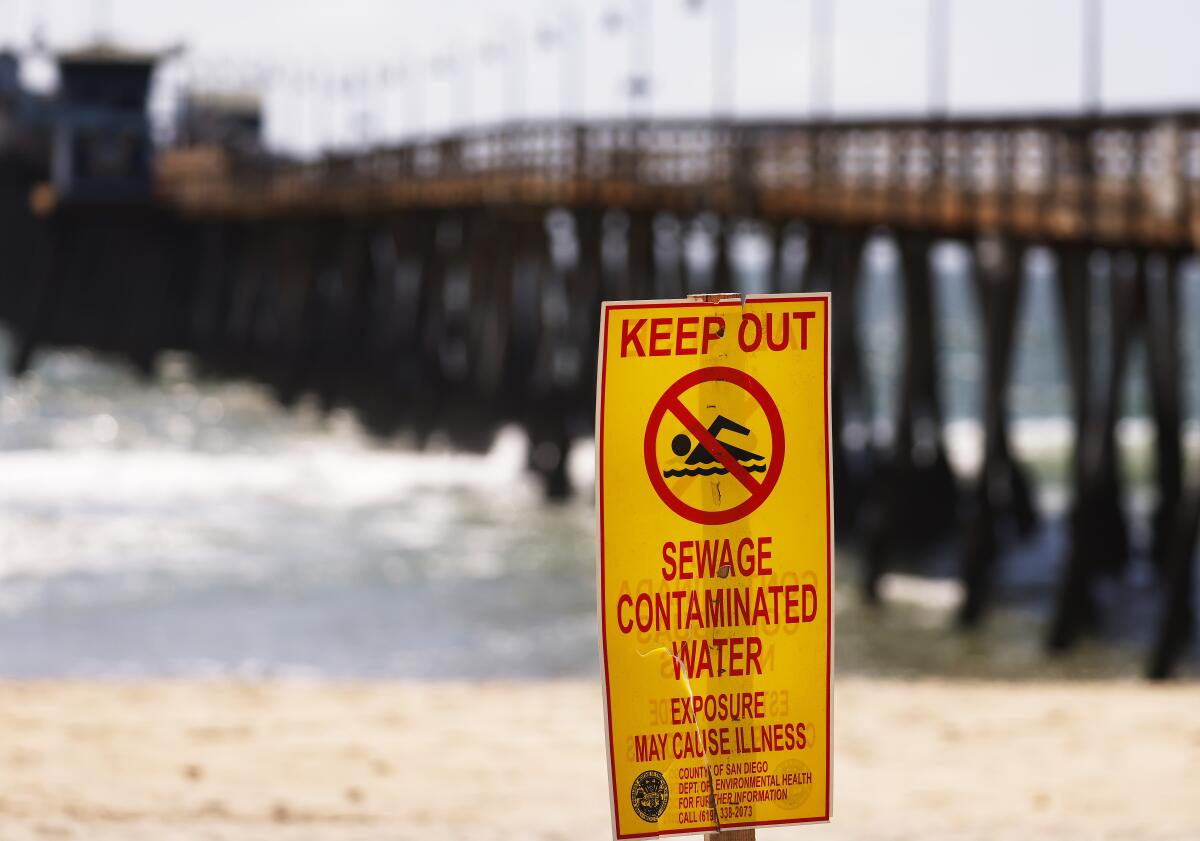 Signs warn people of the contaminated ocean water in Imperial Beach in April.