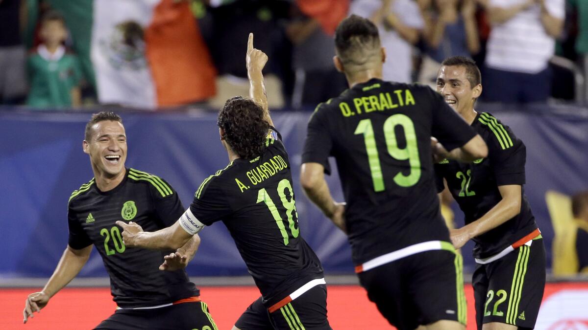 Mexico midfielder Andres Guardado celebrates with teammates after scoring against Jamaica in the first half of their Gold Cup championship game on Sunday in Philadelphia.