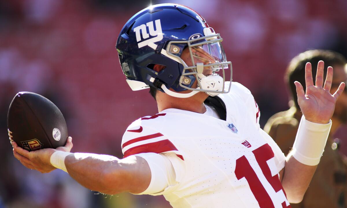 Giants quarterback Tommy DeVito (15) readies to throw against the Commanders.