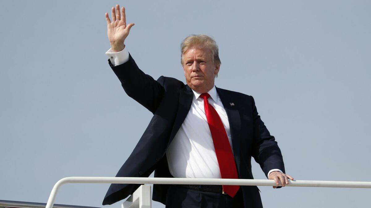 President Trump waves April 18 as he boards Air Force One.