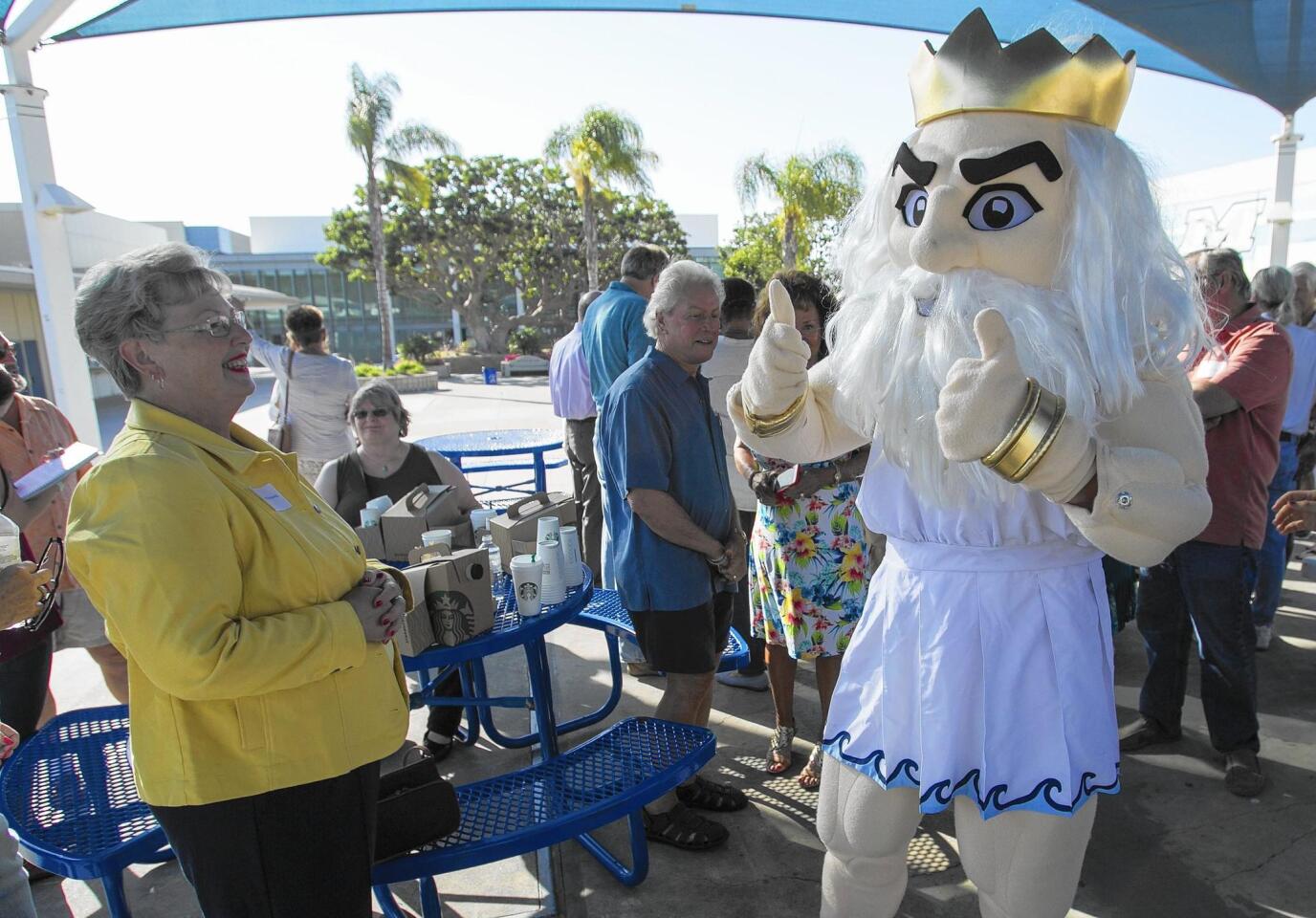 Corona del Mar alumnae Patty Armstrong watches the Sea King's mascot during a tour of the school on Friday.